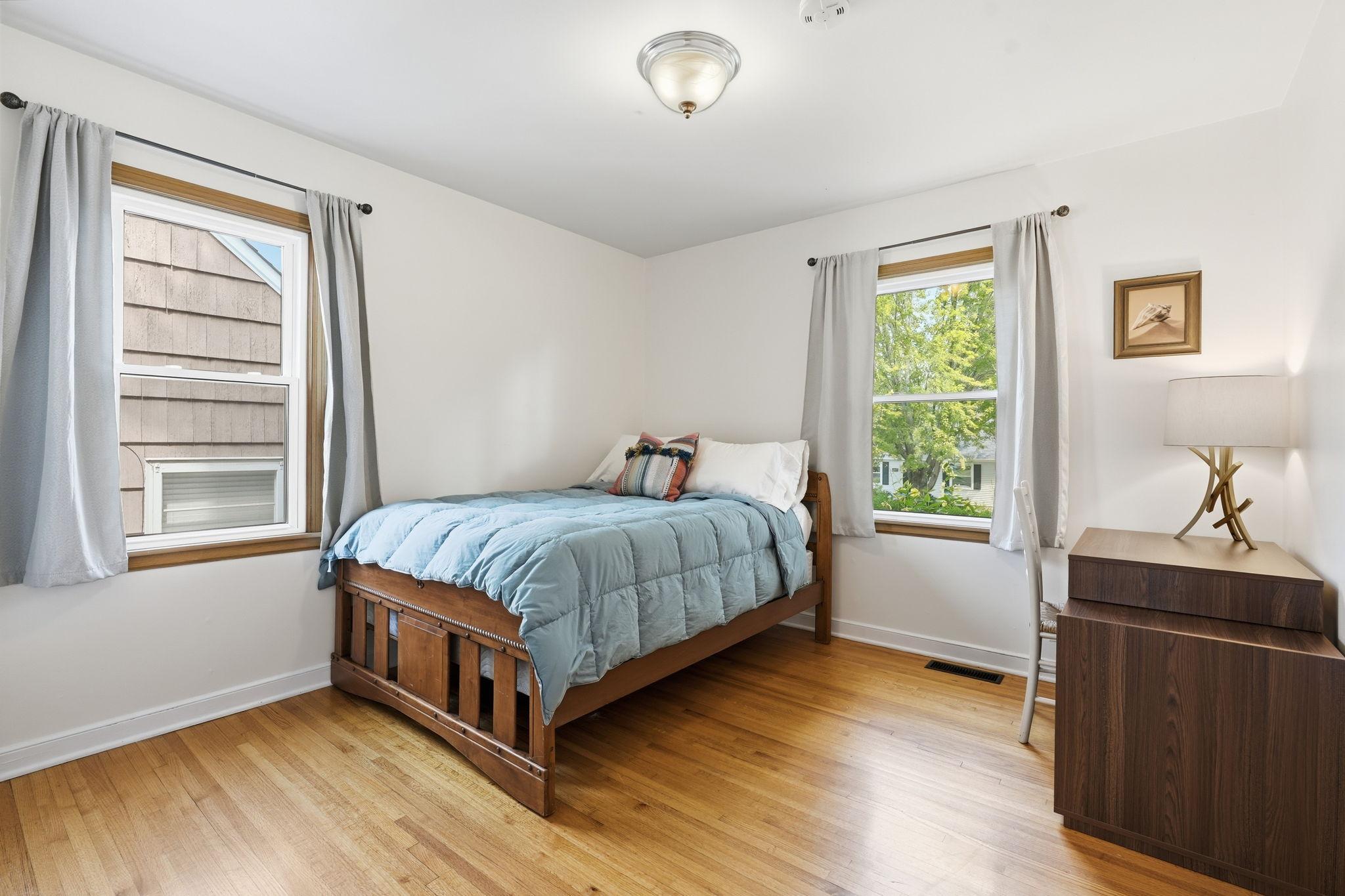 One of two main floor bedrooms with beautiful hardwood floors.
