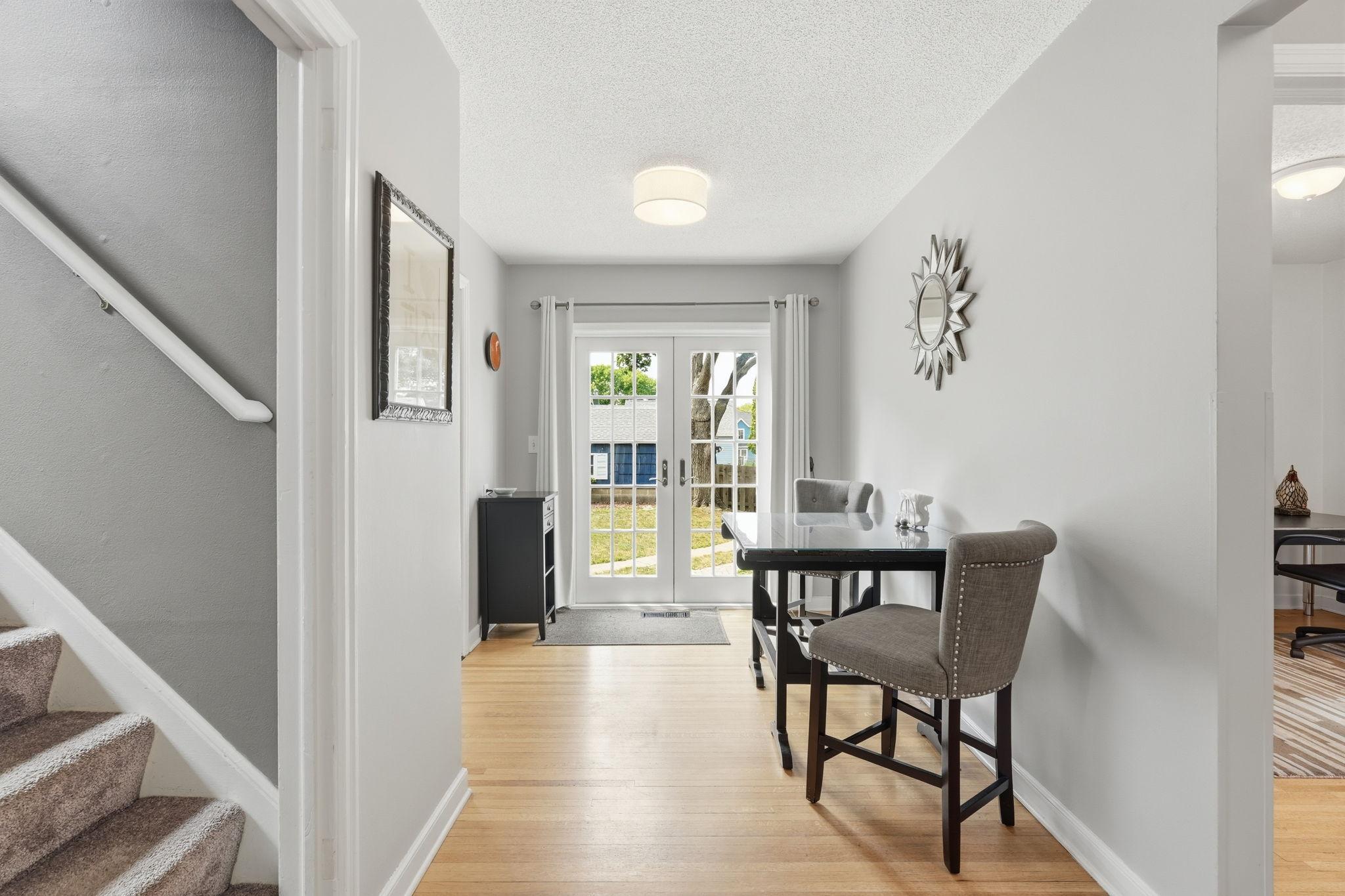 Dining area with French doors leading to backyard paver patio.