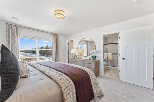 Your own private escape! This owner's suite features a large window and convenient access to the ensuite bathroom. *Photo of a previously built home of the same floor plan. Finishes/options may vary.