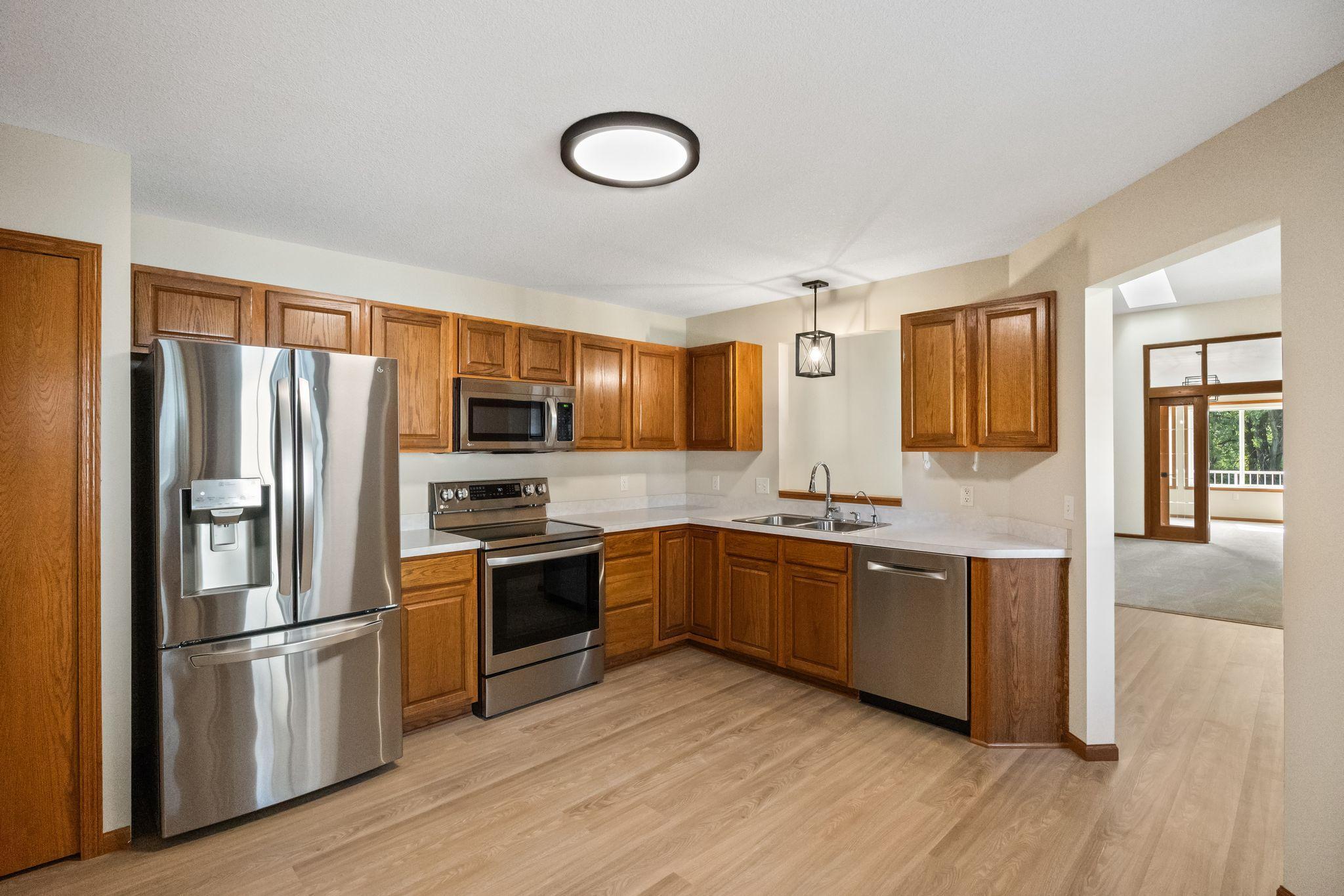 Large kitchen with stainless appliances and easy access to dining area.