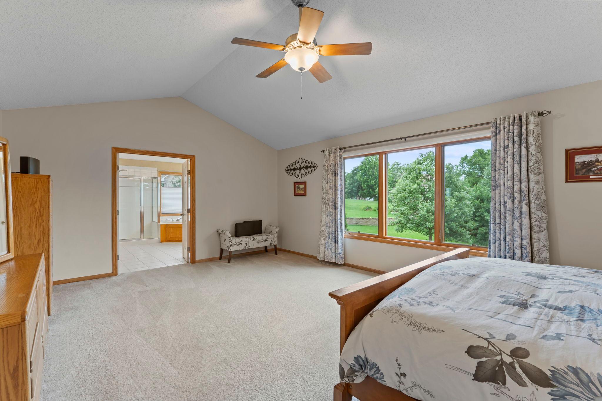 Primary bedroom with ensuite bath and walk-in closet