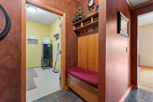 Mudroom includes a built-in bench with hooks and extra storage