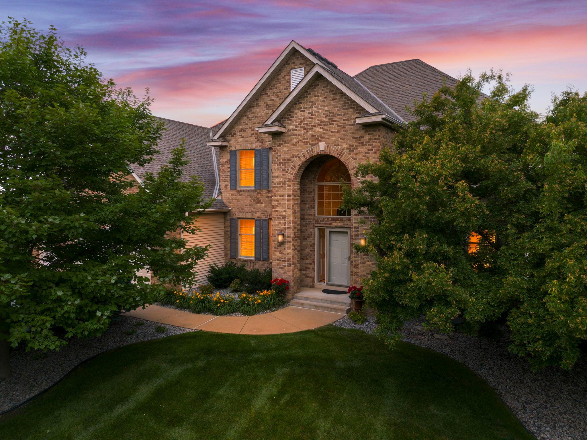 This stately home offers beautiful curb appeal surrounded by mature trees