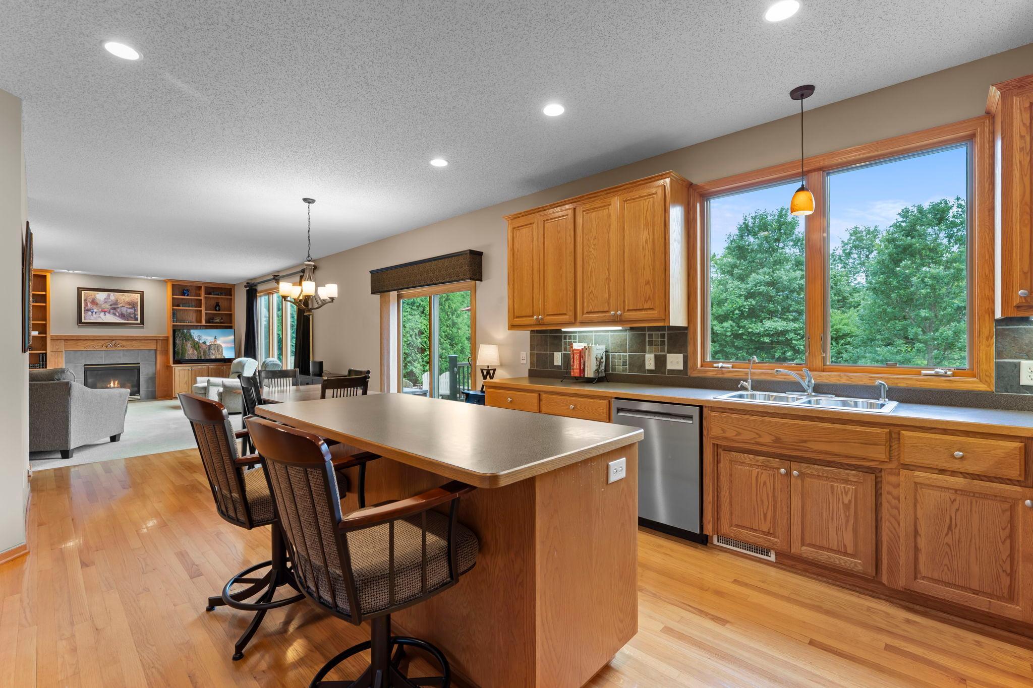 Spacious kitchen with abundant cabinetry, a large center island, and seating for casual meals