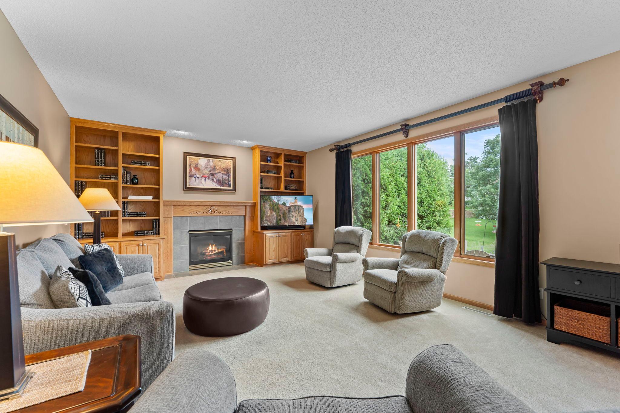 Family room is centered around a gas fireplace and built-ins