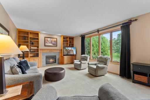 Family room is centered around a gas fireplace and built-ins