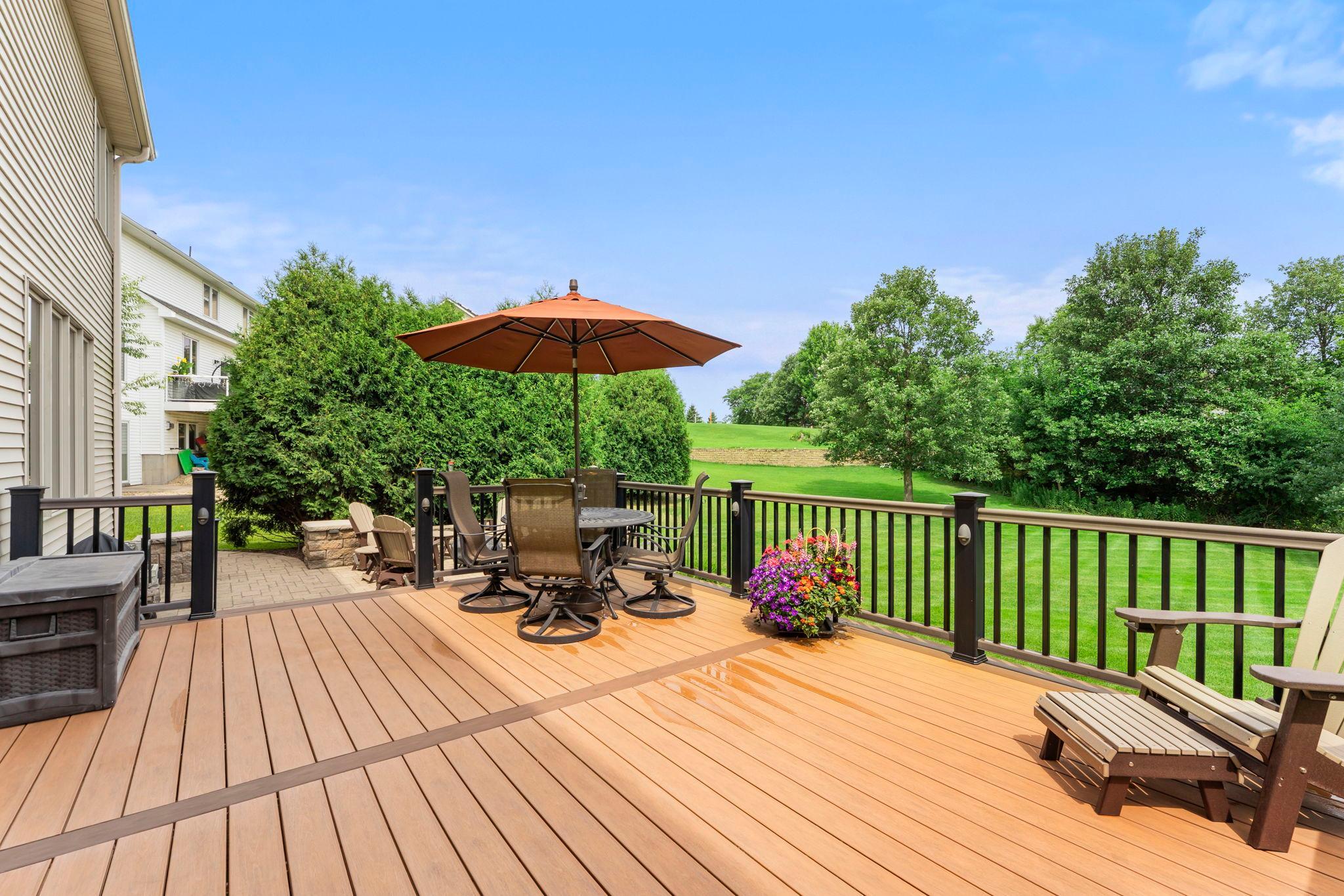 Large deck leads down to the patio, a great space to relax, entertain, grill and more