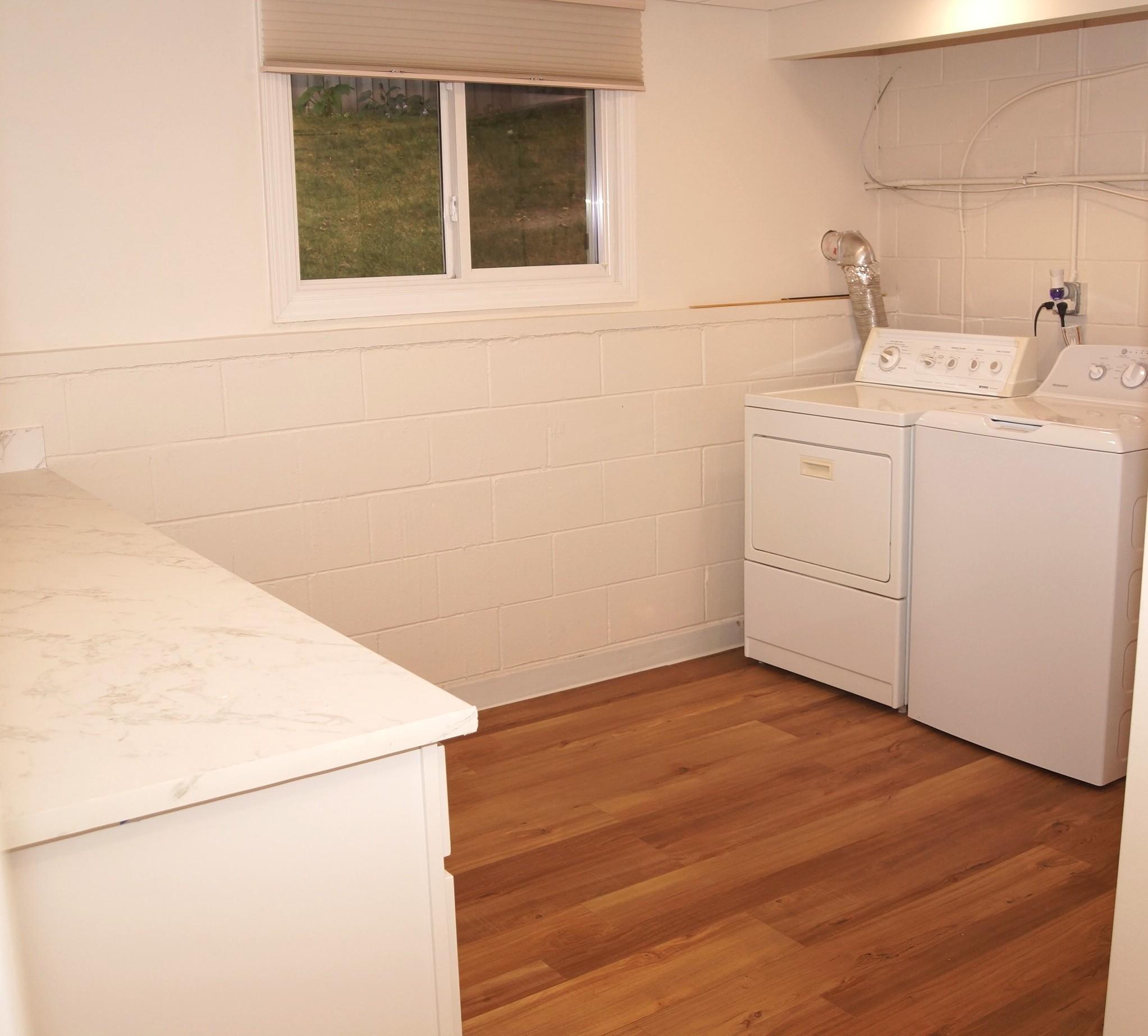 Just painted Laundry Room with new flooring, comes with Washer and Dryer. There is also a new storage cabinet with a nice top for folding clothes.