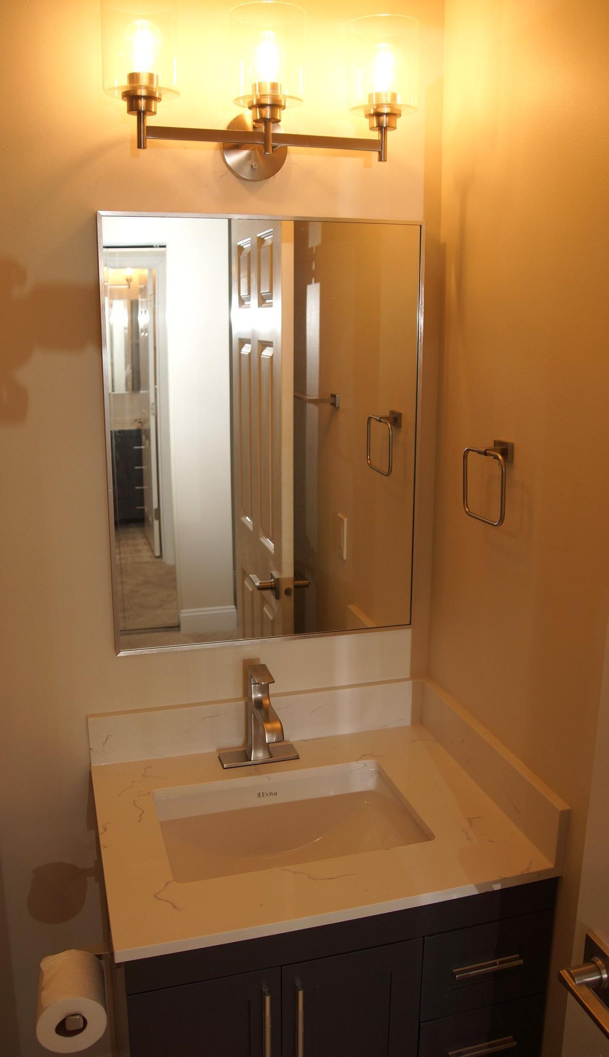 The Bedroom 1 en suite boasts a completely remodeled 3/4 bath, featuring new vanity and Mirror.