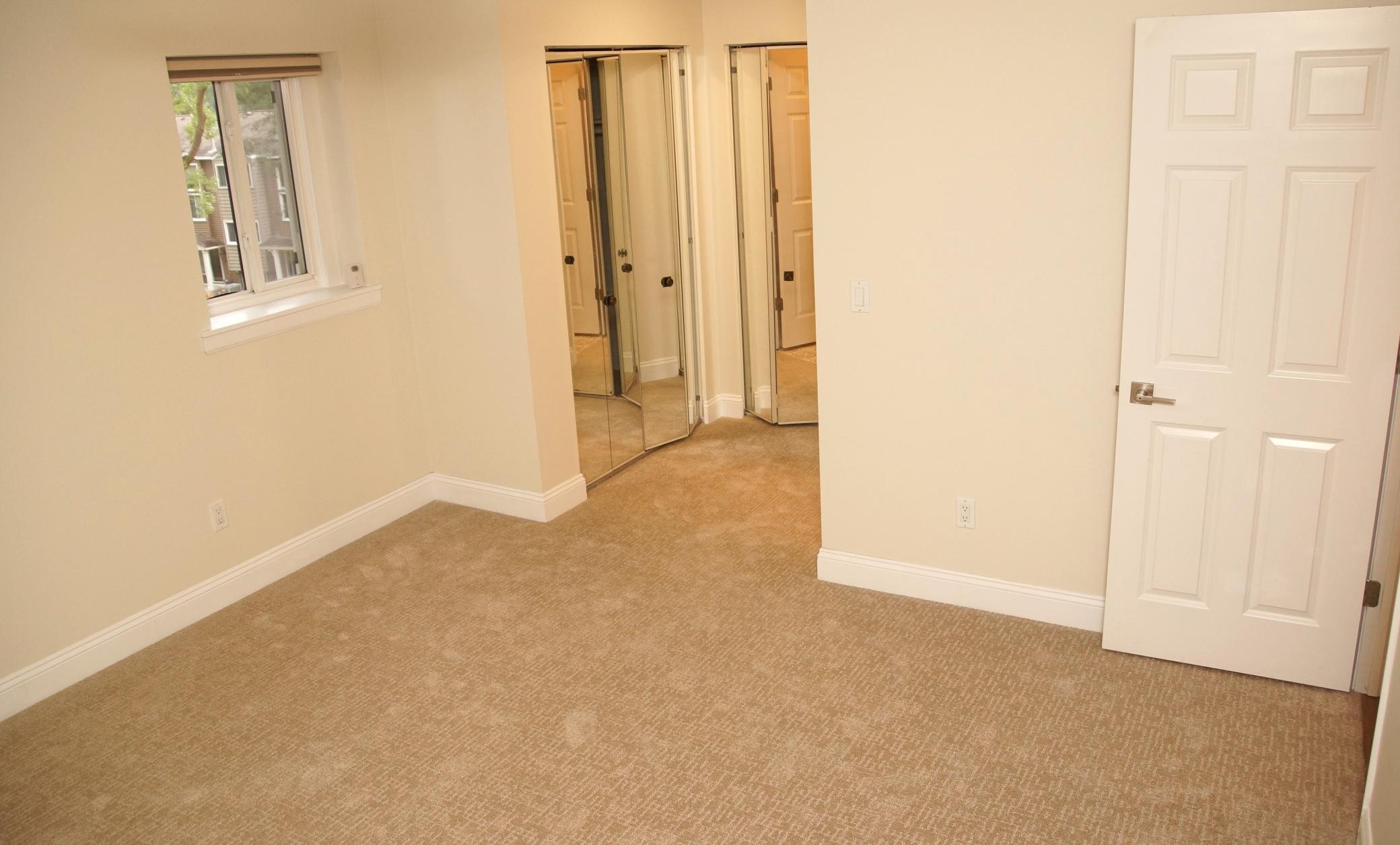 The main floor en suite features ample closet space and a mirrored dressing area adjacent to the 3/4 bath.