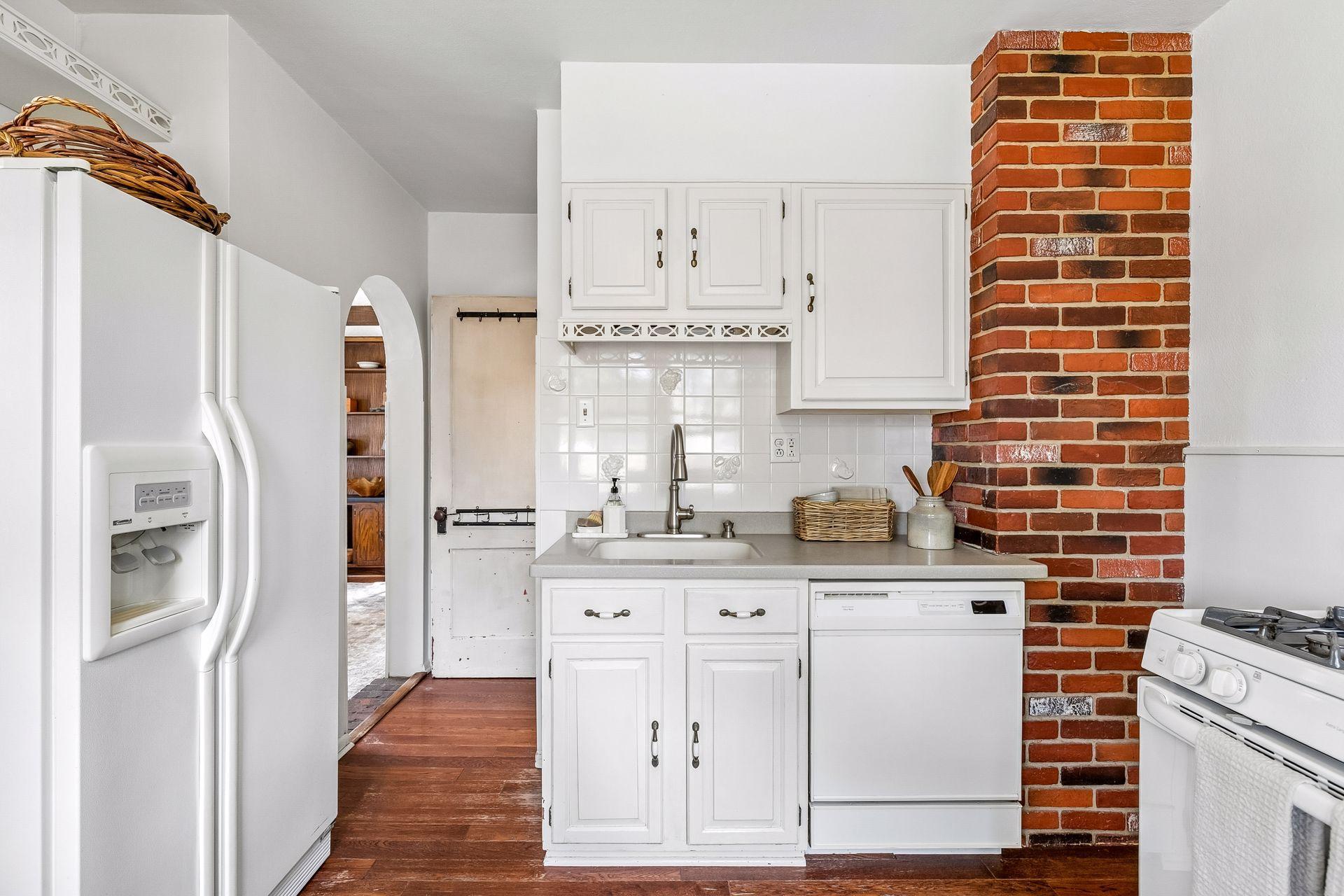 Pass through kitchen to lower level on right or den towards back of home