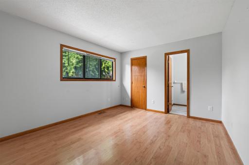 Primary bedroom is on the upper level with walk-in closet and ensuite bathroom