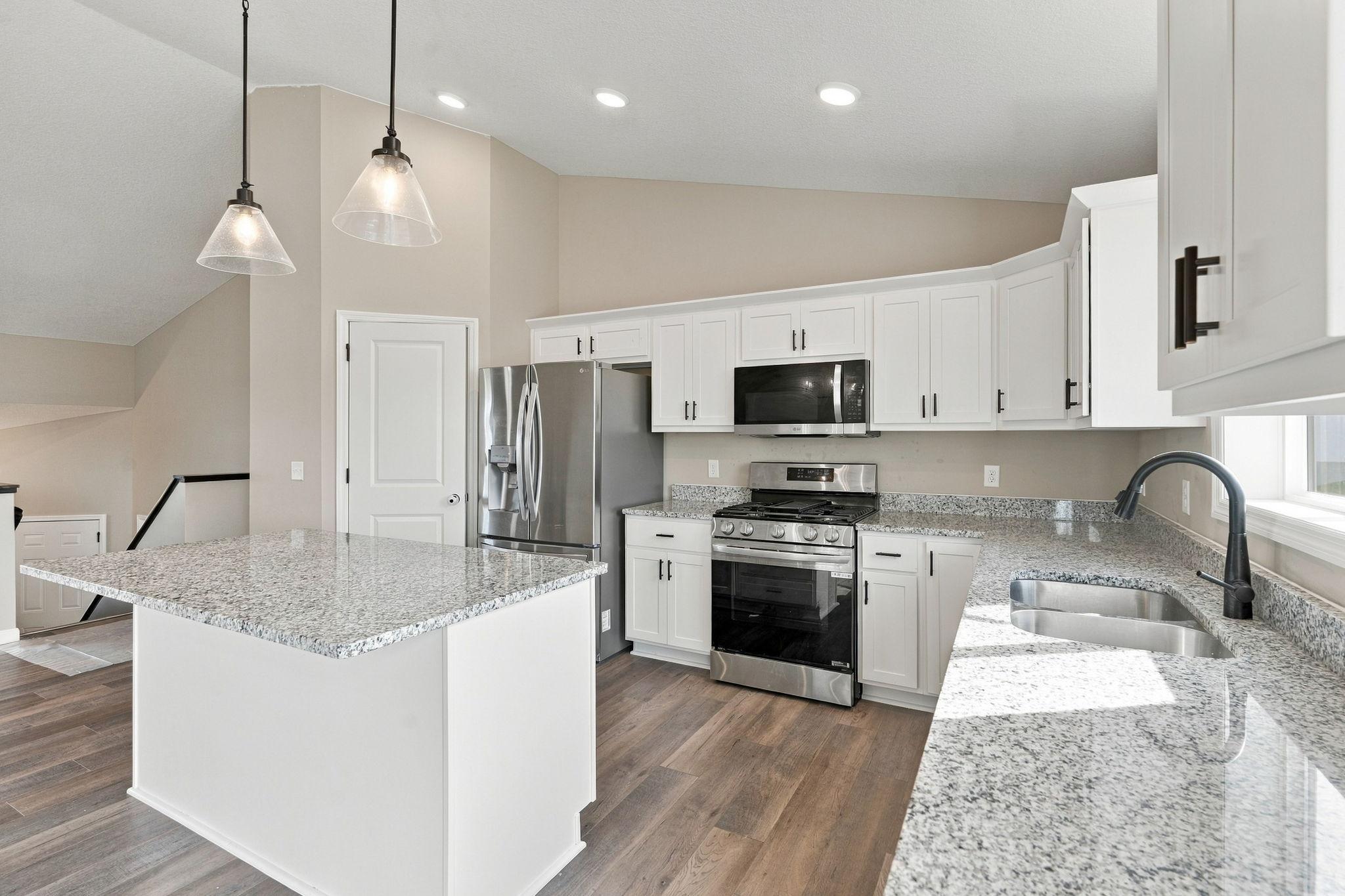 Kitchen features stainless appliances and granite countertops