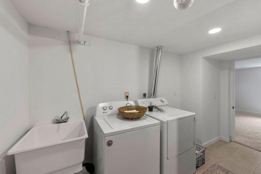 Laundry area with a utility sink provides added convenience for soaking, cleaning, and everyday household needs.
