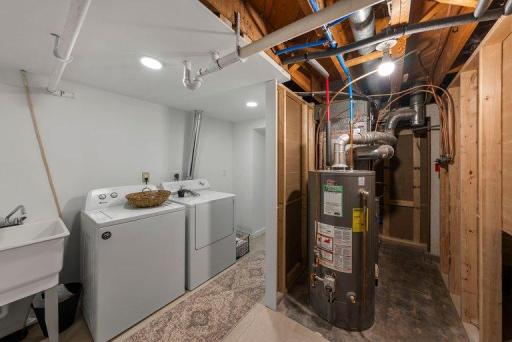 Clean, functional laundry area with modern updates and convenient storage potential.