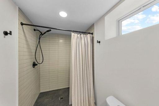 Large walk-in tiled shower adds a spa-like touch to the remodeled lower-level bathroom.