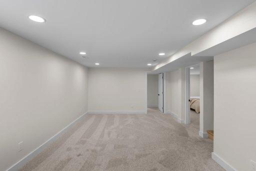 Spacious lower-level family room provides a comfortable gathering space for movie nights, entertaining, games, or relaxation.