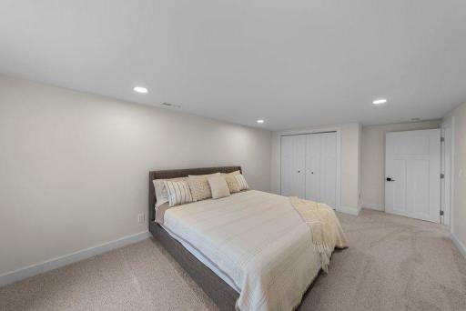 Spacious bedroom offers a comfortable retreat with contemporary finishes, updated lighting, and a clean, modern aesthetic.