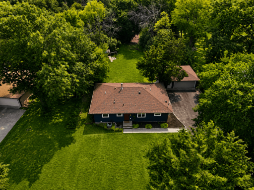 Expansive homesite surrounded by mature trees and established landscaping, creating a peaceful and private setting.
