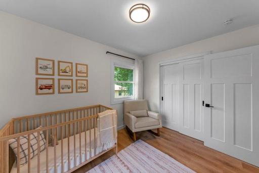 Comfortable secondary bedroom with a clean, contemporary design and durable luxury vinyl plank flooring.