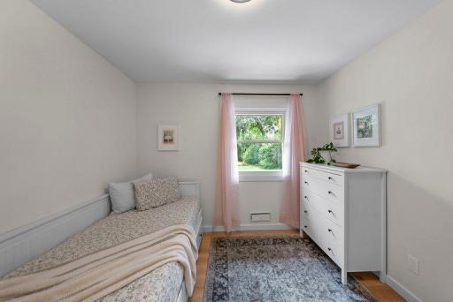 Bedroom with updated finishes, modern lighting, and luxury vinyl plank flooring.