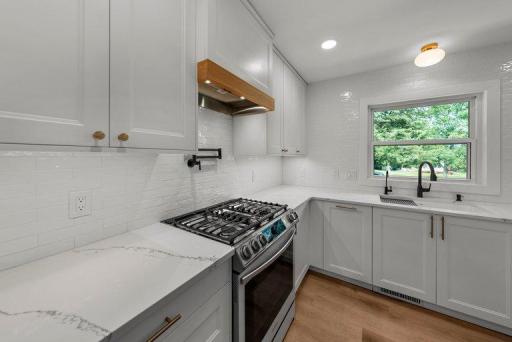 Stylish quartz countertops and custom cabinetry combine modern design with functional storage.
