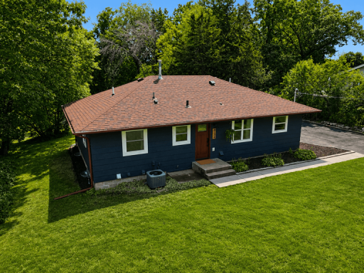 New driveway leads to the beautifully landscaped front yard, creating a clean and inviting approach to the home.