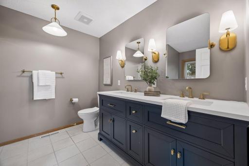 The primary bathroom is classy with double sinks.