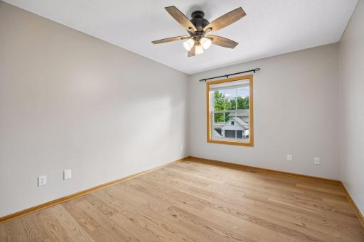 The upper level bedroom. There are a total of four - one being the primary bedroom. These rooms have all been freshly painted with a beautiful neutral color.