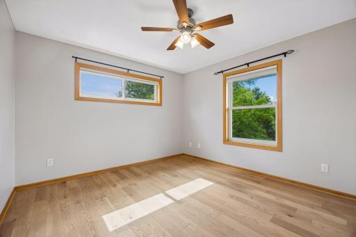 The upper level bedroom. There are a total of four - one being the primary bedroom. These rooms have all been freshly painted with a beautiful neutral color.
