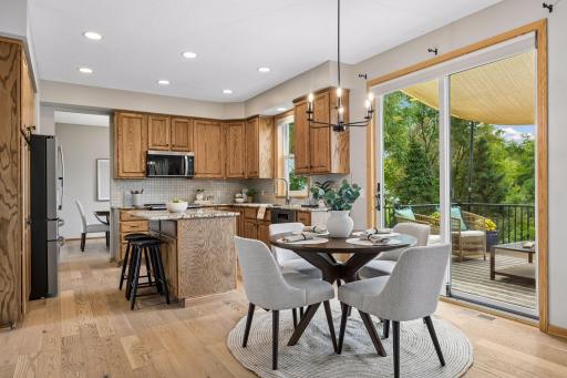 The informal dining room area to the kitchen, with a quick view of the back deck.