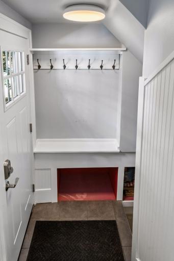 Charming mudroom hooks and storage areas and brand new exterior door.