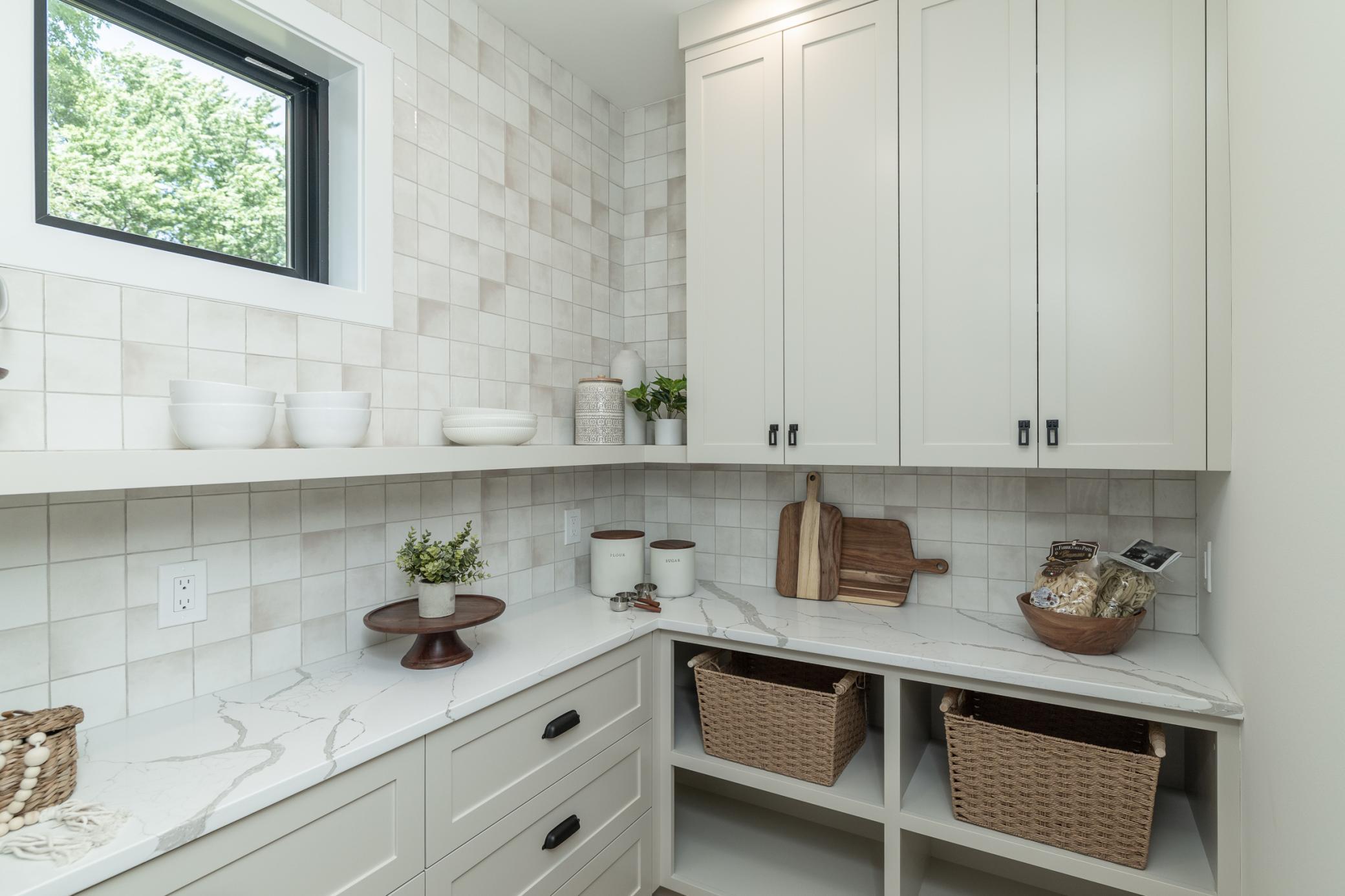 Custom cabinets, quartz counters and natural light in pantry