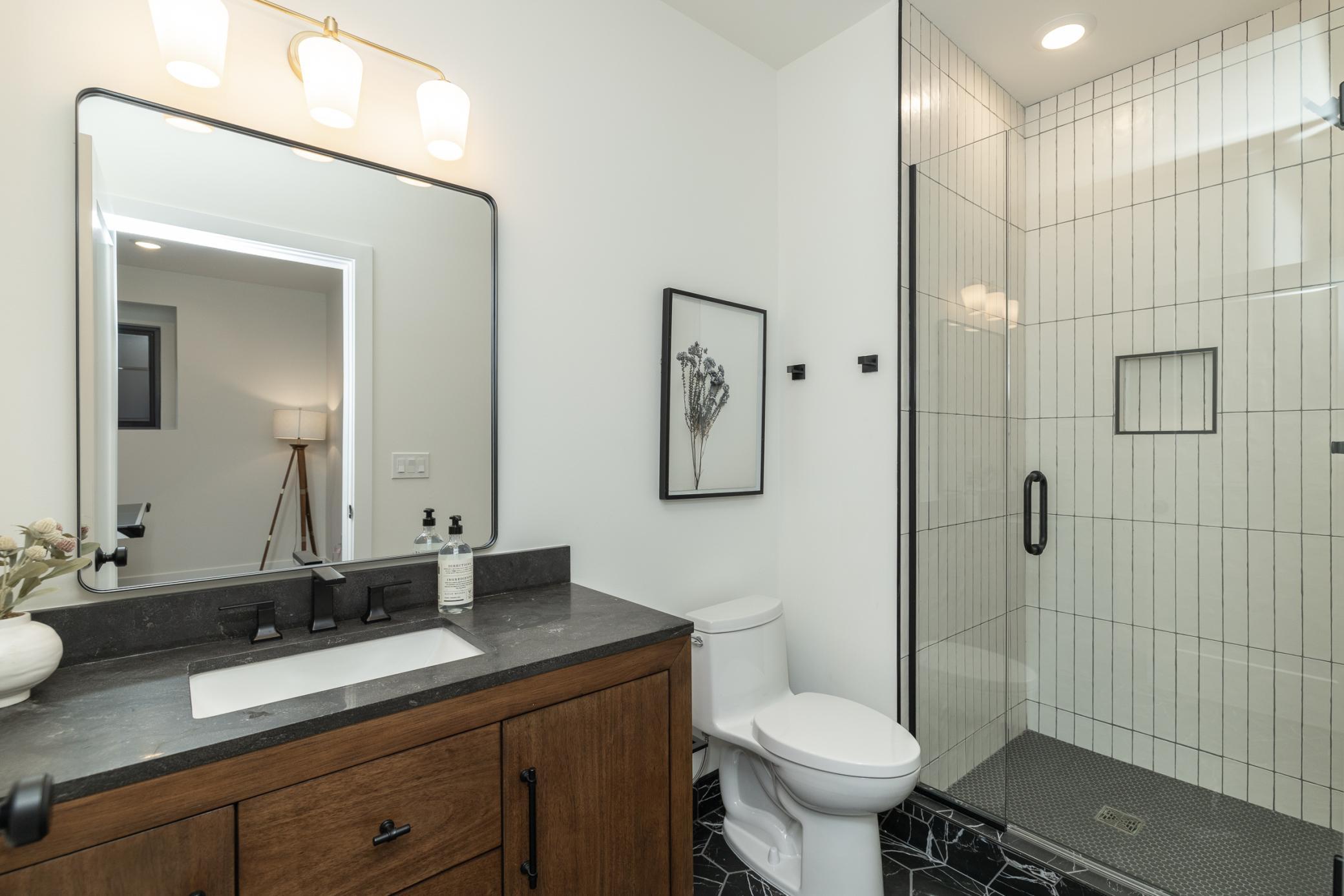 Beautiful lower level 3/4 bath with custom built shower