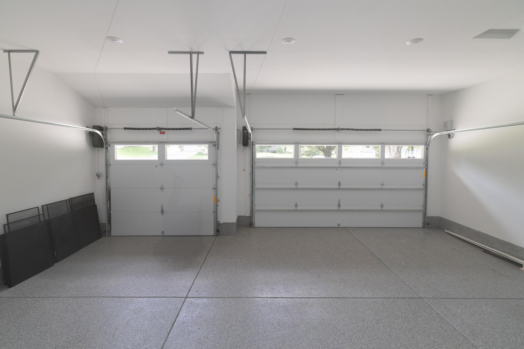 3-car heated garage with epoxy floor and 8' doors