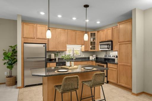 The kitchen features granite countertops, stainless steel appliances, plenty of cabinet space, and a convenient snack bar