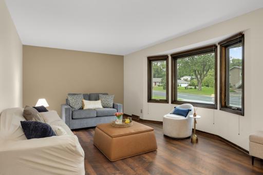 Large updated windows bring in wonderful natural light while highlighting the home's warm and welcoming main level.