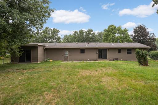 A spacious, fully fenced backyard surrounded by mature trees creates a private outdoor setting with room to make it your own.