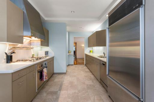 A sleek, well-designed kitchen featuring abundant cabinetry, generous counter space