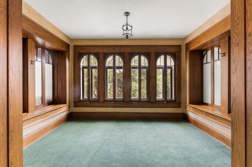 A shared sunroom, wrapped in rich original woodwork