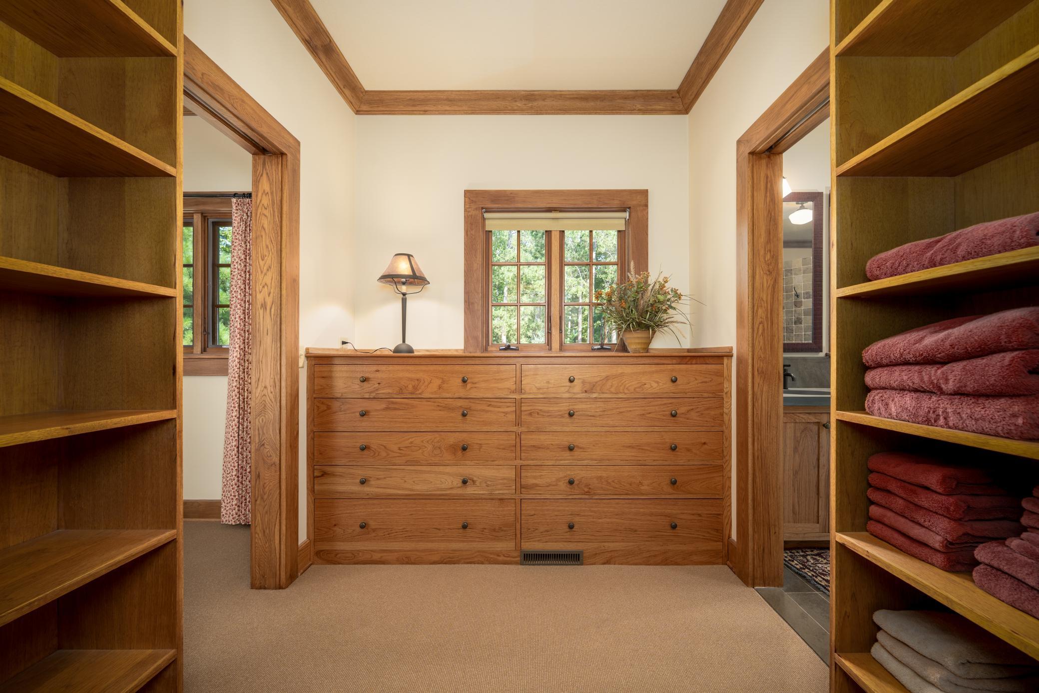 Primary walk-in closet with custom built-ins and shelving!