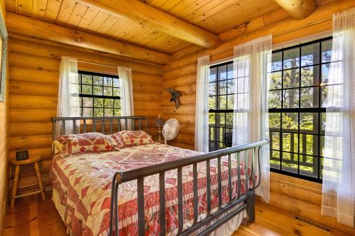 Main level primary bedroom with lakeside windows