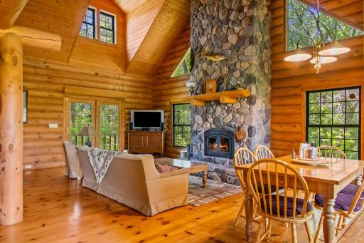 Vaulted living room with floor to ceiling stone fireplace