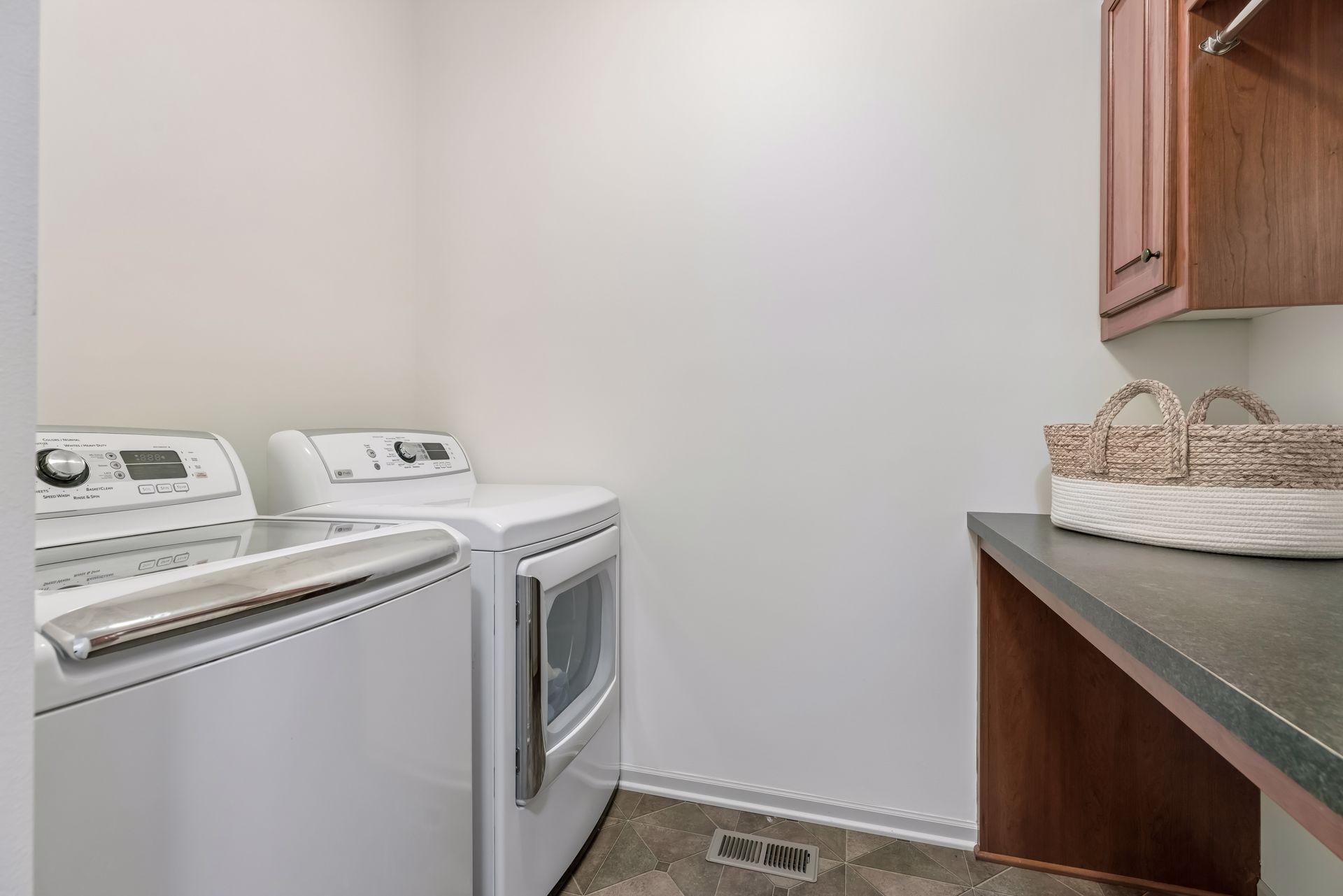 Main level laundry complete with folding table, storage, and drying area.