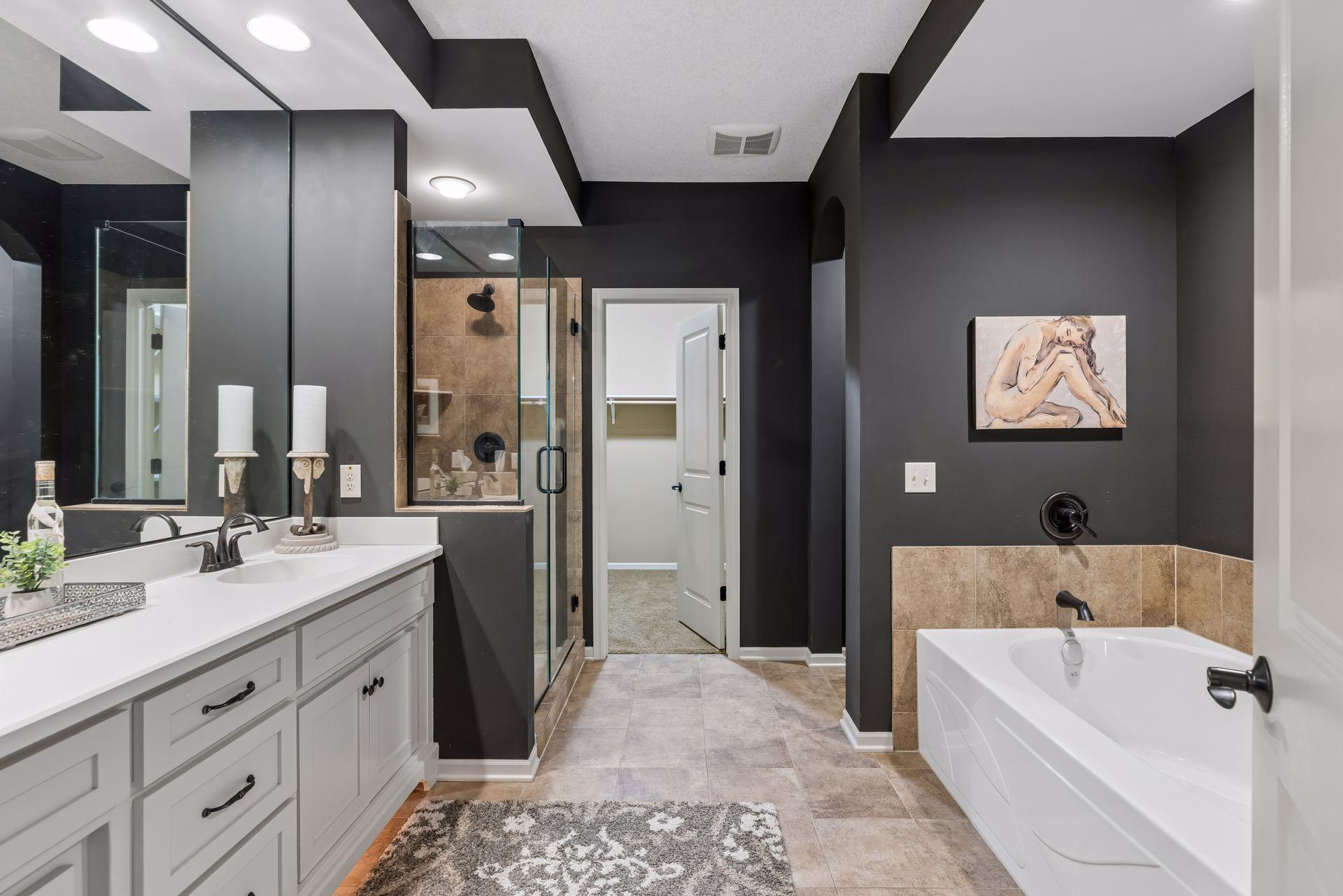 Oversized primary suite features double vanity, a soaking tub and walk-in shower.