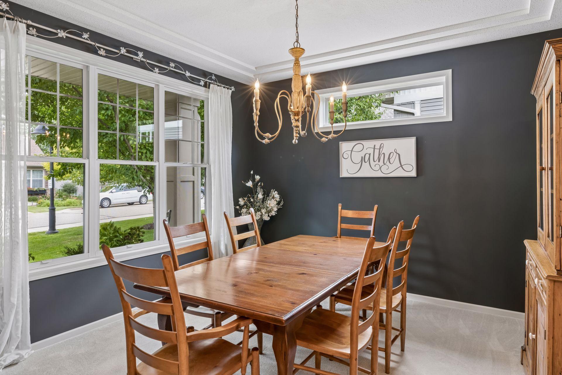 Formal dining room sits at the front of the home and features a stacked ceiling and elegant chandelier.