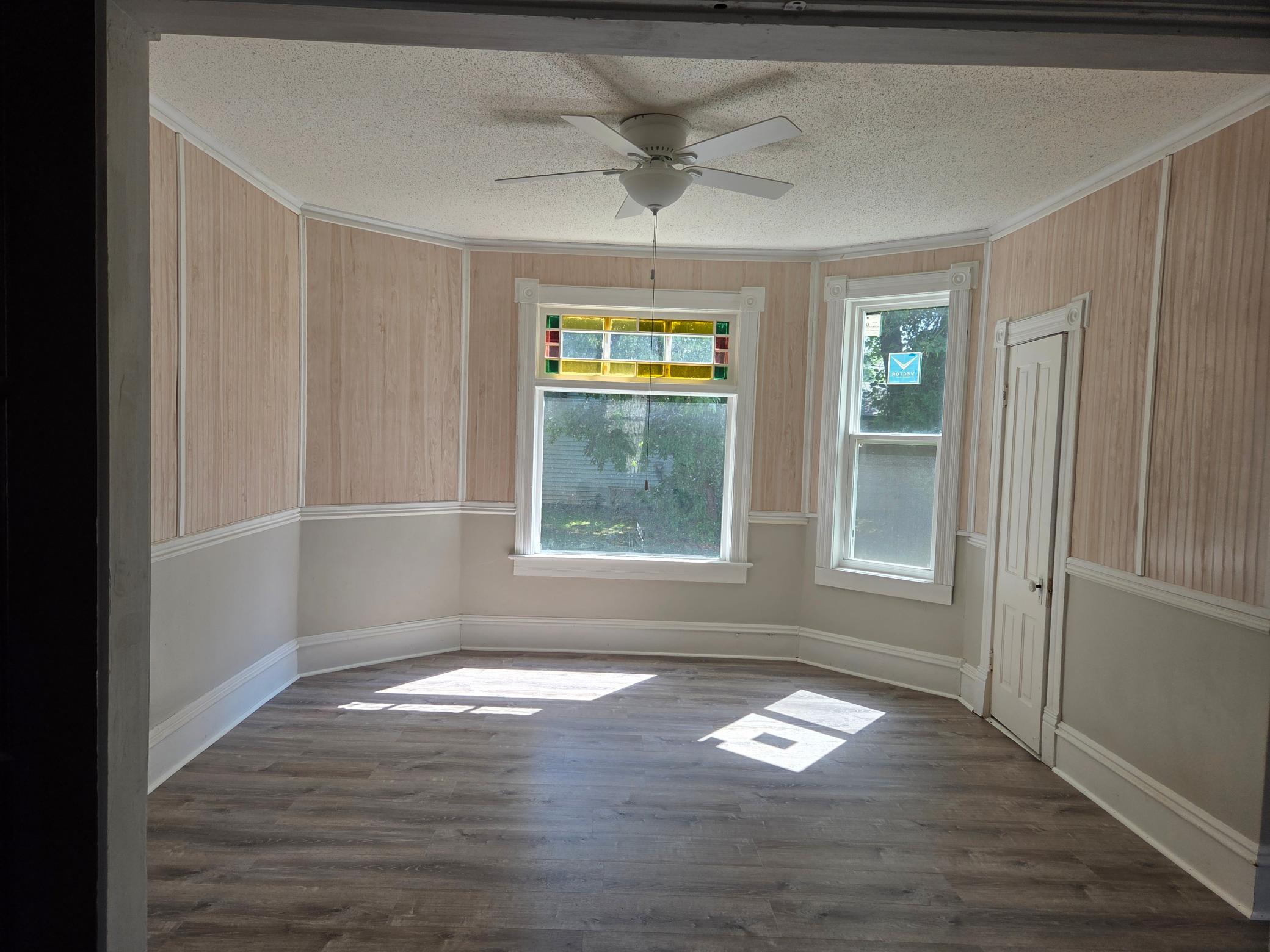 formal dining room with new flooring and overhead fan