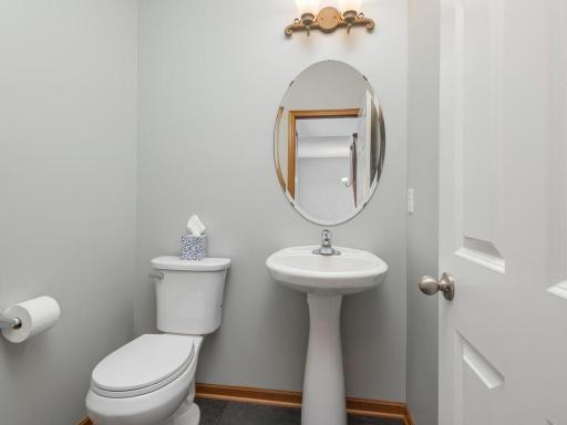 Updated main floor powder bath with new toilet, new flooring & freshly painted.