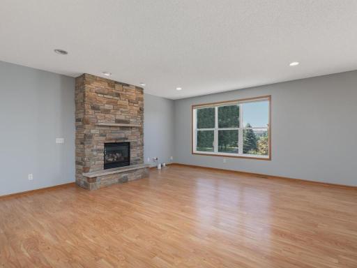 Bright & beautiful great room with large windows filling the space with natural light & southern sunshine! An impressive floor to ceiling stone fireplace is a gorgeous focal point for the main level.