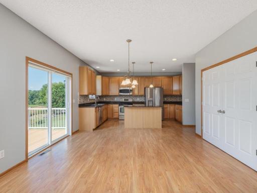 A generous kitchen & informal dining area with center island breakfast bar & large pantry.